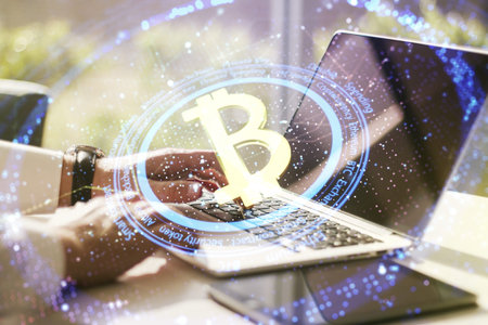 Creative Bitcoin concept with hands typing on computer keyboard on background. Double exposureの写真素材