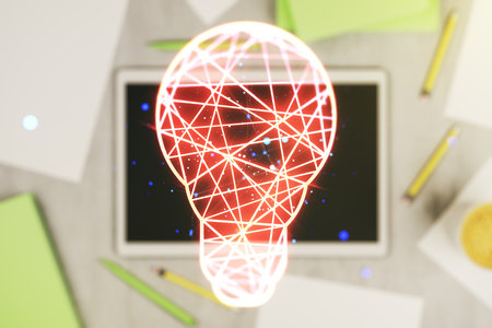 Creative light bulb hologram and modern digital tablet on background, idea concept. Multiexposureの写真素材