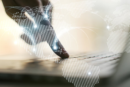 Double exposure of abstract digital world map with connections and hands typing on laptop on background, research and strategy conceptの写真素材