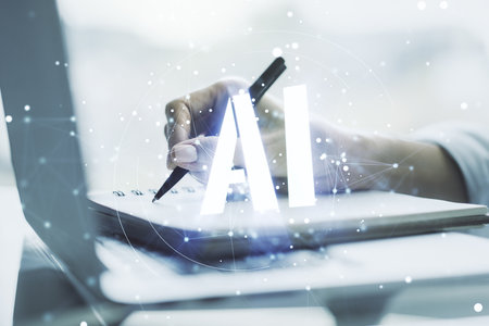 Creative artificial Intelligence symbol concept with hand writing in notebook on background with laptop. Multiexposureの写真素材