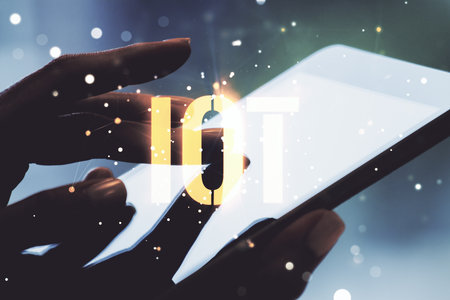 Creative IOT hologram and hand working with a digital tablet on background, internet of things concept. Multiexposureの写真素材