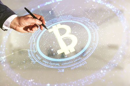 Man hand with pen working with virtual Bitcoin hologram on blurred office background. Multiexposureの写真素材