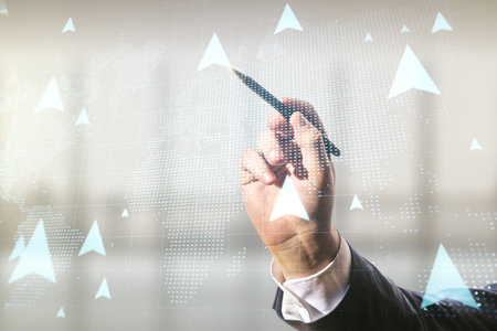 Man hand with pen draws abstract virtual GPS locator sketch with world map on blurred office background, monitoring and tracking concept. Multi exposureの写真素材