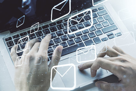 Creative concept of postal envelopes illustration with hands typing on laptop on background. Email and communications concept. Multiexposureの写真素材