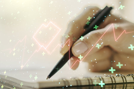 Creative abstract heart rate sketch and woman hand writing in notepad on background, Medicine and healthcare concept. Multiexposureの写真素材