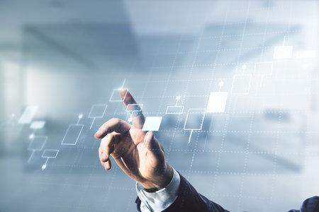 Multi exposure of trader hand clicks on virtual abstract financial graph interface on blurred office background, financial and trading conceptの写真素材