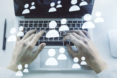 Double exposure of social network icons concept with hands typing on laptop on background. Marketing and promotion conceptの写真素材