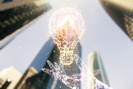 Double exposure of creative light bulb hologram on modern skyscrapers background, research and...