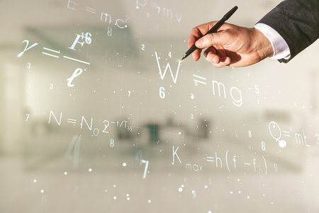 Man hand with pen working with scientific formula hologram on blurred classroom background, research concept. Multiexposureの写真素材