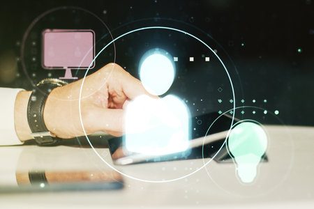 Double exposure of social network icons concept and hand working with a digital tablet on background. Networking conceptの写真素材