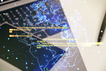 Multi exposure of abstract software development hologram with world map on laptop background, global research and analytics conceptの写真素材