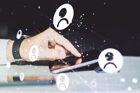 Double exposure of social network icons concept and hand working with a digital tablet on background. Networking conceptの写真素材