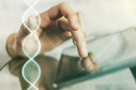 Creative light DNA illustration and finger presses on a digital tablet on background, science and biology concept. Multiexposureの写真素材