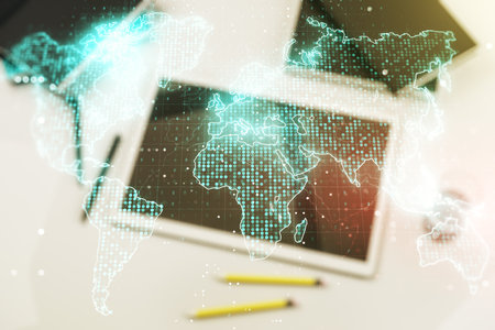 Double exposure of abstract digital world map and modern digital tablet on background, big data and blockchain conceptの写真素材