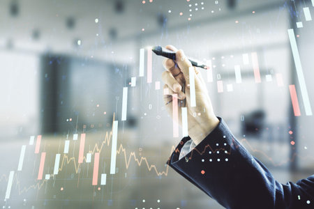 Man hand with pen working with abstract virtual financial graph on blurred office background,...