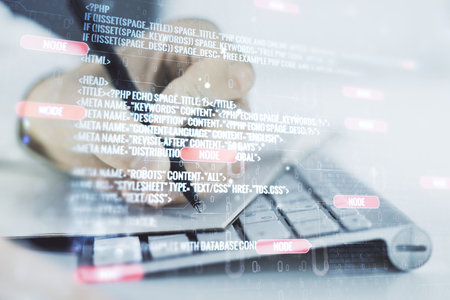 Double exposure of abstract programming language with hand writing in notebook on background with laptop, research and development conceptの写真素材