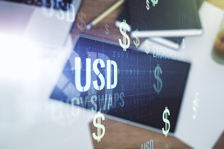 Creative concept of USD symbols illustration and modern digital tablet on background, top view. Trading and currency concept. Multiexposureの写真素材