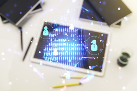Social network media concept with world map and modern digital tablet on desktop on background, top view. Double exposureの写真素材
