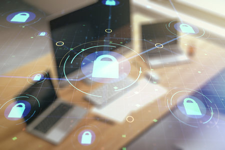 Double exposure of creative lock hologram with chip and modern desktop with laptop on background. Information security conceptの写真素材