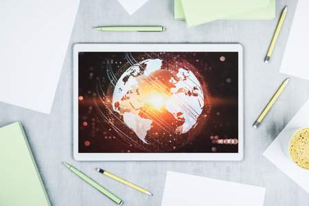 Top view of modern digital tablet display with abstract graphic world map, big data and networking concept. 3D Renderingの写真素材
