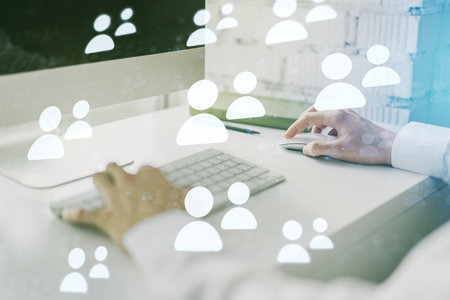 Double exposure of social network icons concept with hand typing on computer keyboard on background. Networking conceptの写真素材