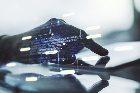 Multi exposure of abstract programming language hologram and hand working with a digital tablet on background, artificial intelligence and machine learning conceptの写真素材