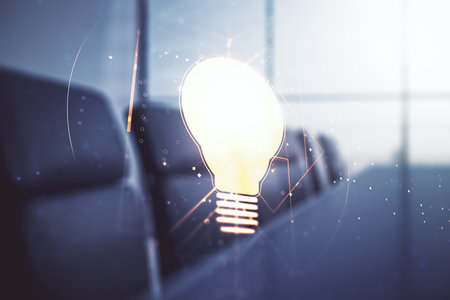 Abstract virtual light bulb hologram on a modern boardroom background, idea concept. Multiexposureの写真素材