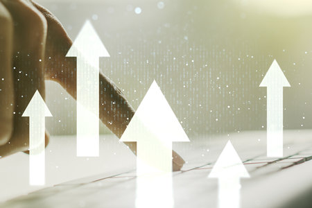 Creative concept of upward arrows illustration and hands typing on laptop on background. Breakthrough and progress concept. Multiexposureの写真素材