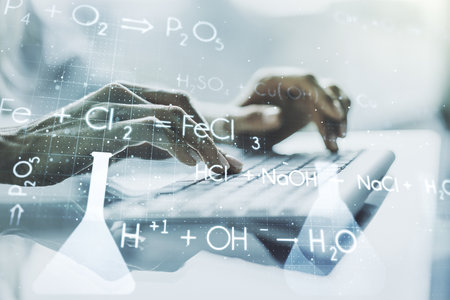 Double exposure of creative chemistry concept with hands typing on laptop on background, research and development conceptの写真素材