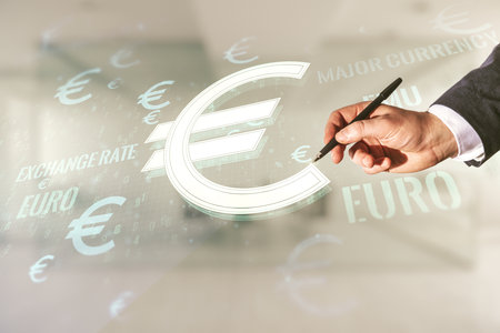 Man hand with pen working with virtual EURO symbols illustration on blurred office background, forex and currency concept. Multiexposureの写真素材