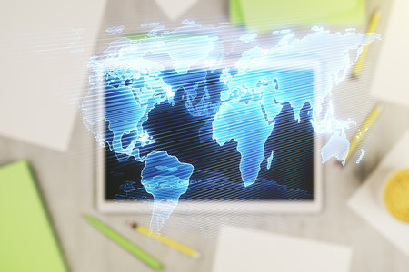 Multi exposure of abstract graphic world map and modern digital tablet on desktop on background, top view, big data and networking conceptの写真素材