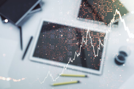 Multi exposure of abstract creative financial chart with world map and digital tablet on background, top view, research and analytics conceptの写真素材