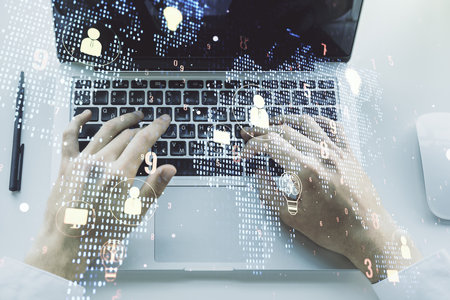Double exposure of social network icons concept with world map and hands typing on laptop on background. Marketing and promotion conceptの写真素材