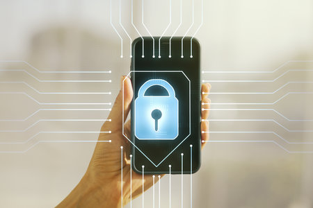 Double exposure of creative lock hologram with chip and hand with cell phone on background. Information security conceptの写真素材