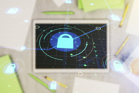 Double exposure of creative lock hologram with chip and digital tablet on background, top view. Information security conceptの写真素材