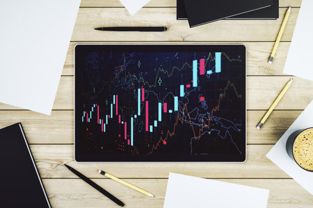 Modern digital tablet monitor with abstract creative financial chart, research and analytics concept. Top view. 3D Renderingの写真素材