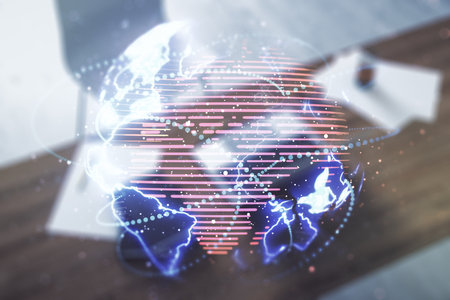 Double exposure of abstract digital world map with connections and modern desk with computer on background, big data and blockchain conceptの写真素材