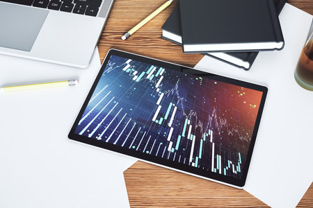 Modern digital tablet monitor with abstract creative financial chart, research and strategy concept. Top view. 3D Renderingの写真素材
