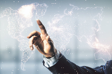 Man hand working with abstract creative world map interface on blurred office background, international trading concept. Multiexposureの写真素材