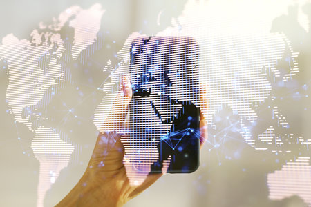 Multi exposure of abstract creative digital world map and hand with cell phone on background, research and analytics conceptの写真素材