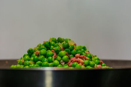 Peas with ham and onion a pan and ready to serveの写真素材