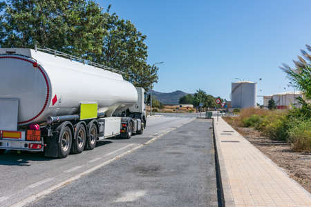Fuel tanker next to the storage tanks where the product to be transported is loaded.の写真素材