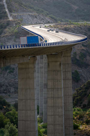 Truck circulating through a viaduct that makes a curve showing the depth of the fall.の写真素材
