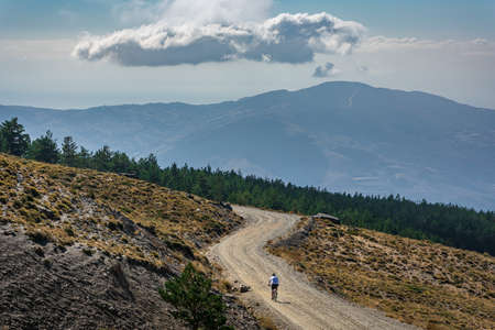 Man practicing sport by bicycle in the summits of Sierra Nevada, Granada.の写真素材