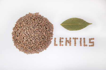 Lentils, name written on a white background with the legume itself next to a handful of them.の写真素材