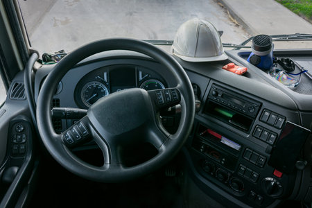 Personal protective equipment in the cabin of a truck that transports dangerous goods, consisting of a helmet, protective glasses, gas mask and an explosimeter.の写真素材