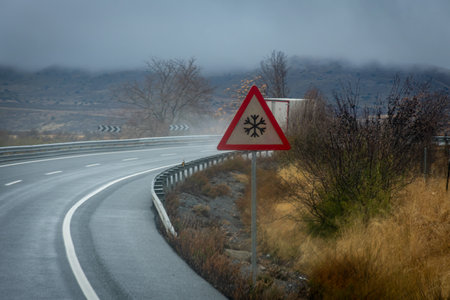 Traffic sign warning of the possibility of snow or ice on the road.の写真素材