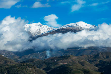 Landscape of the southern slope of Sierra Nevada, with the summit of Pico del Caballo covered in...