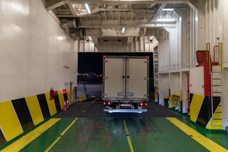 Truck leaving the cargo hold of a ferry boat.