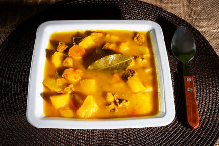 Potato stew with beef and carrot on a square plate.の写真素材